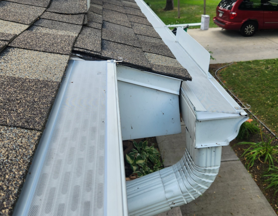 Silver micro-mesh gutter guard installed on a roof with gray shingles